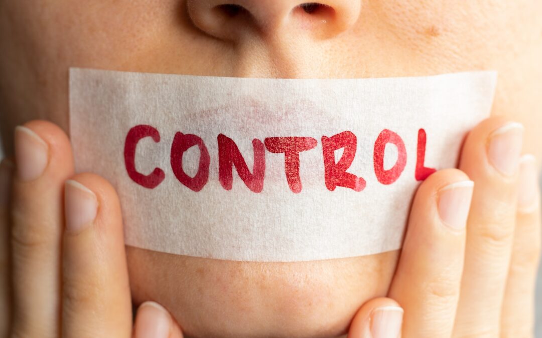 control written on tape over woman's mouth